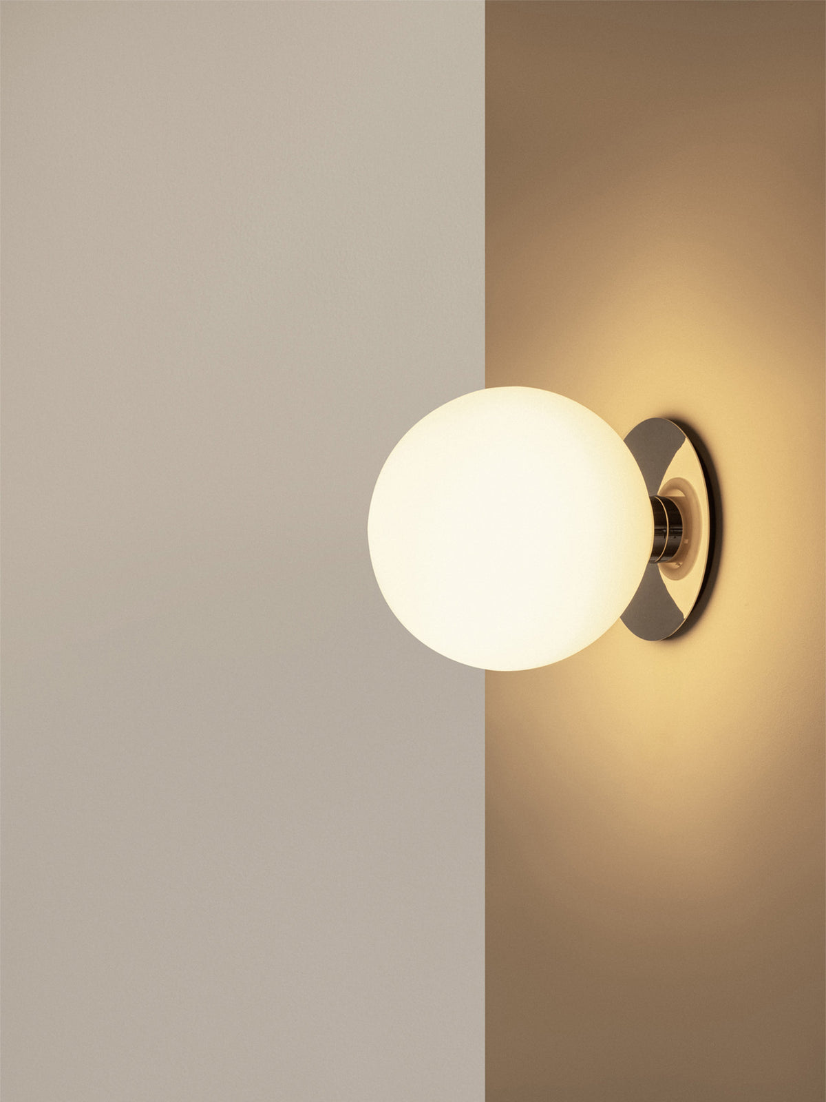 Wall-mounted round opal glass globe light with polished chrome circular base cas