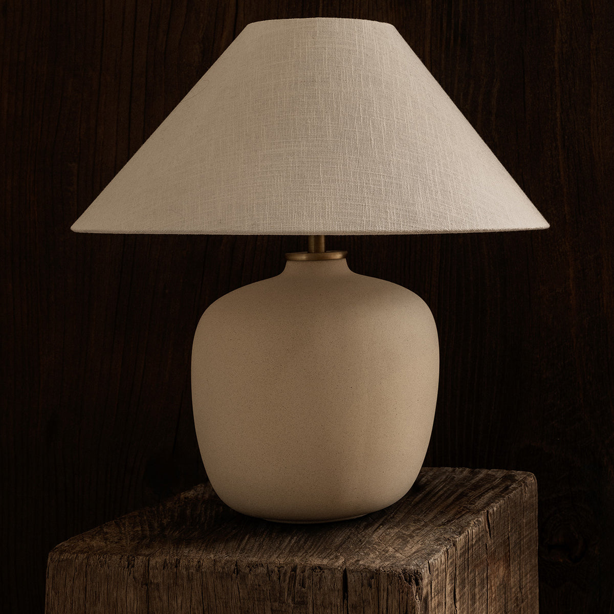Beige ceramic table lamp with a matching fabric shade, positioned on a