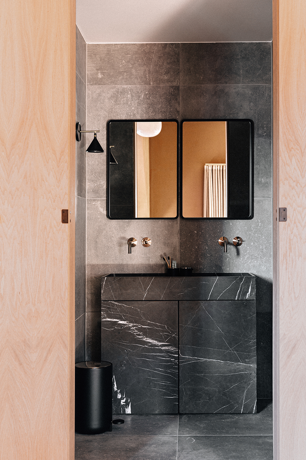 Minimal bathroom with dark grey marble vanity, black basin, dual rectangular mir