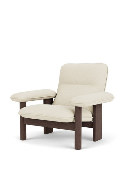 Angled view of the Brasilia Lounge Chair with a high back, featuring a dark wood frame and plush cream bouclé upholstery.