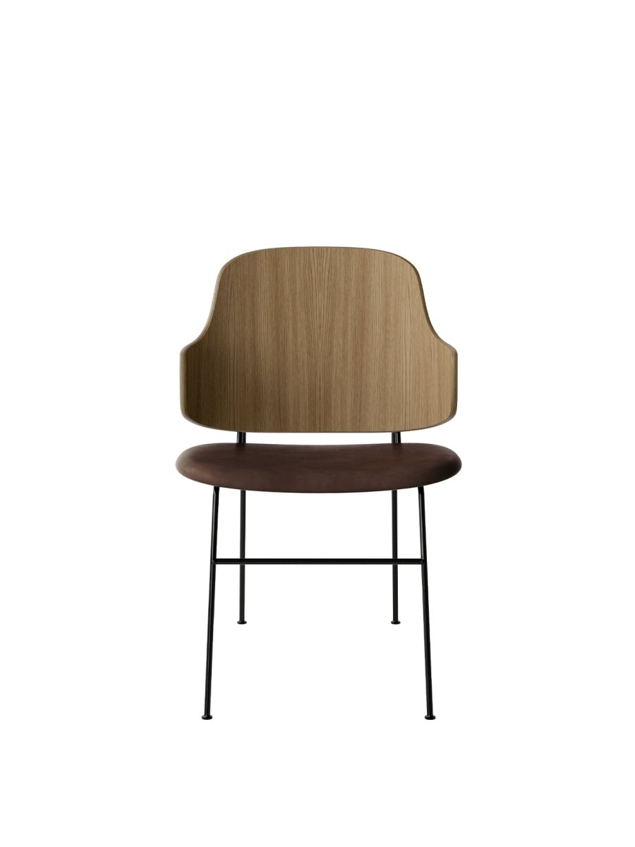Front view of The Penguin Dining Chair with a curved oak back and brown leather upholstered seat on black steel legs.