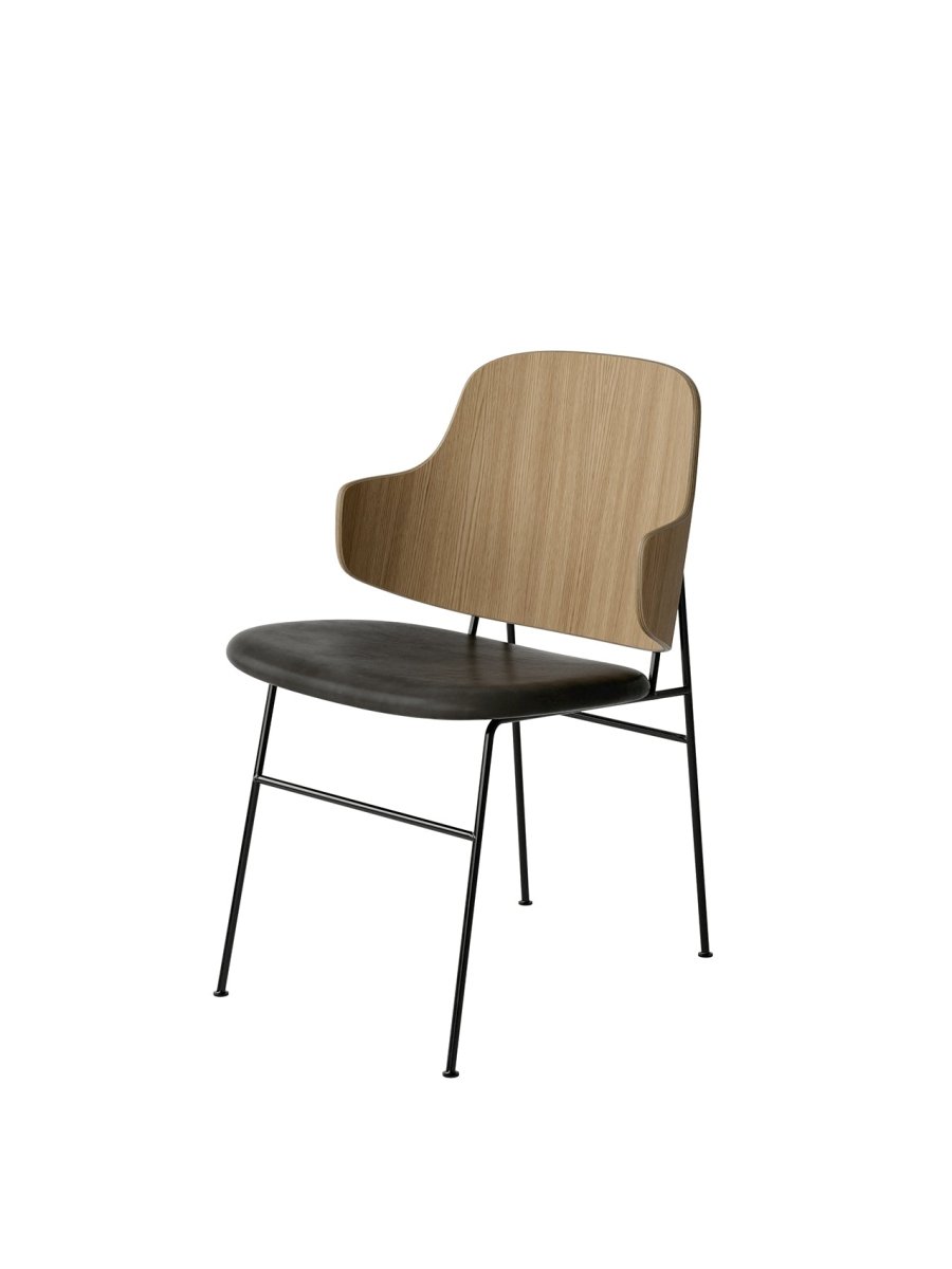 The Penguin Dining Chair with a curved oak veneer back and dark upholstered seat on a black steel frame.