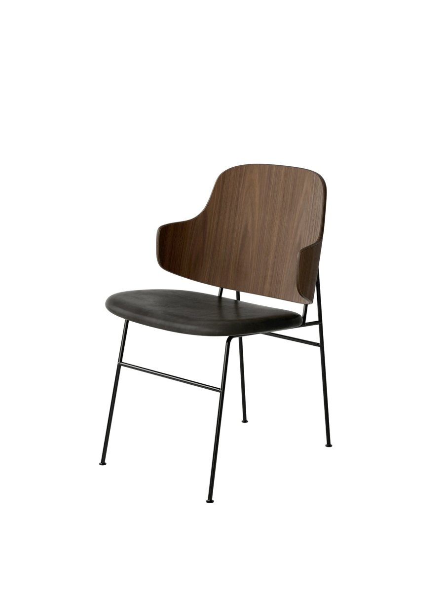 The Penguin Dining Chair featuring a curved walnut back and black upholstered seat on a slim black steel frame.