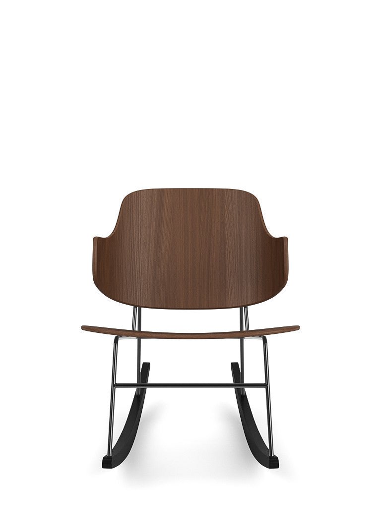 The Penguin Rocking Chair seen from the front, featuring a curved walnut veneer back and seat on a black steel rocking base.
