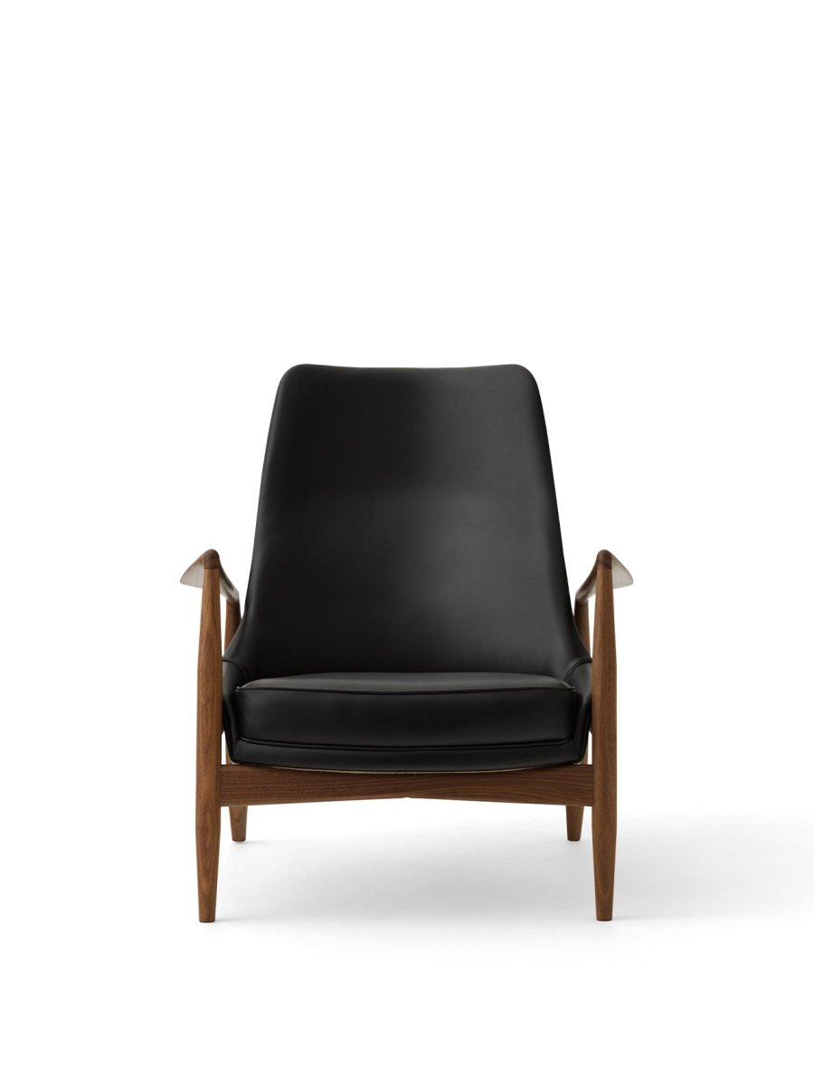 Front view of The Seal Lounge Chair, High Back in oiled walnut and dark leather upholstery against a white background.