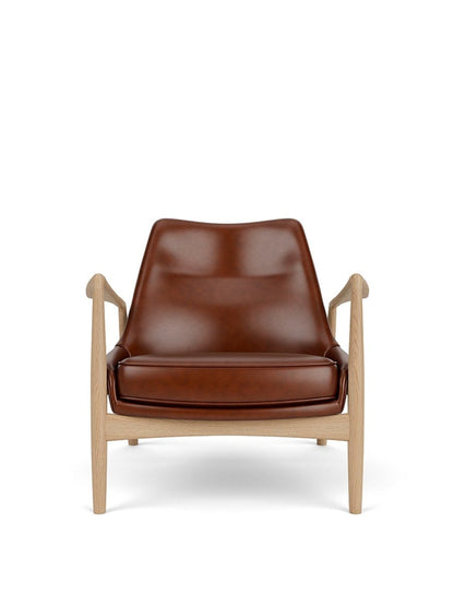Front view of The Seal Lounge Chair, Low Back, featuring a natural oak frame and brown leather upholstery.