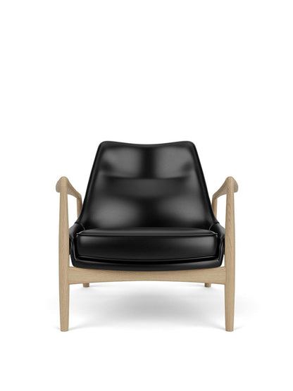 Front view of The Seal Lounge Chair, Low Back, upholstered in black leather with a natural oak frame.