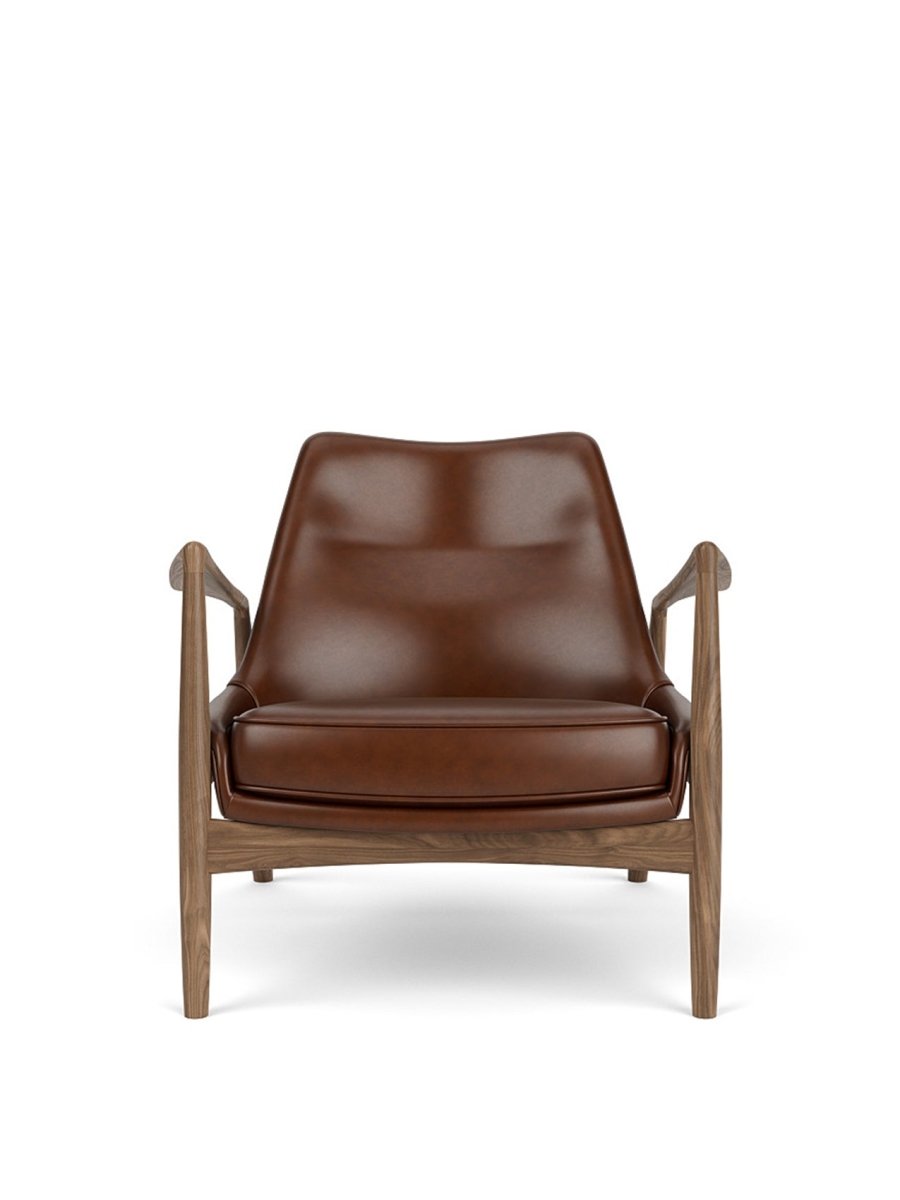 Front view of The Seal Lounge Chair, Low Back in walnut with brown leather upholstery against a white background.