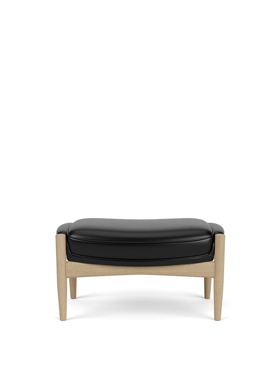 The Seal Ottoman in natural oak with dark leather upholstery shown from the front against a white background.