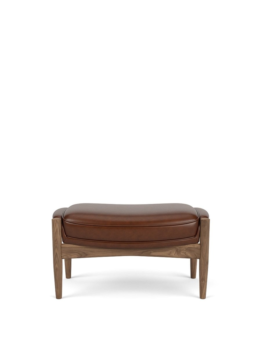 Front view of The Seal Ottoman in oiled walnut featuring brown Dakar leather upholstery against a white background.