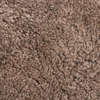 Close-up of plush brown Sheepskin, Sahara showcasing the soft, curly texture and natural fur quality.