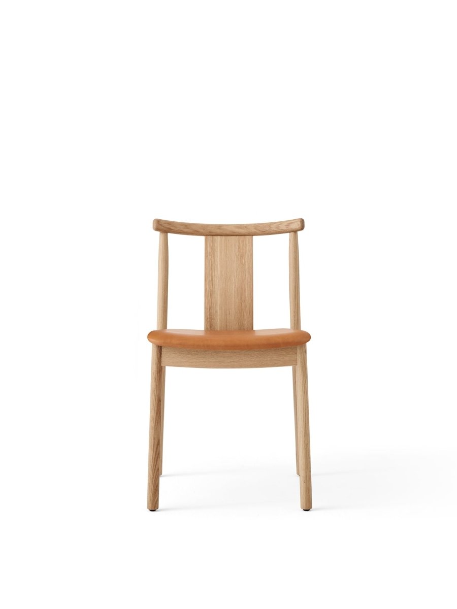 Front view of the Merkur Dining Chair without armrests, featuring a natural oak frame and a tan leather seat.