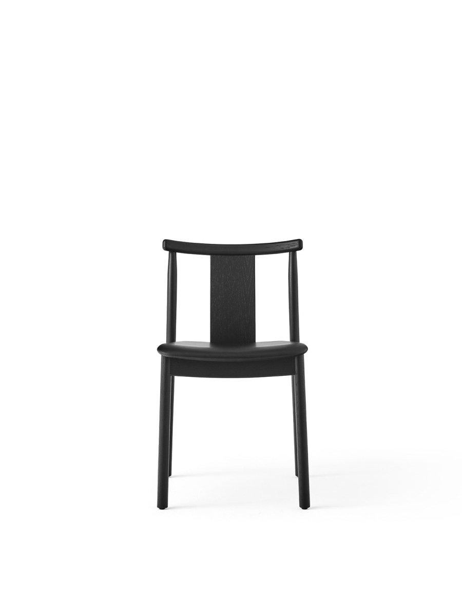 Front view of the Merkur Dining Chair, Without Armrests, in black stained solid oak with a minimalist silhouette.