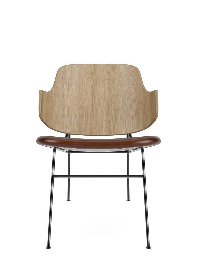 The Penguin Lounge Chair seen from the front, with a natural oak back and a brown Dakar 0329 leather upholstered seat.