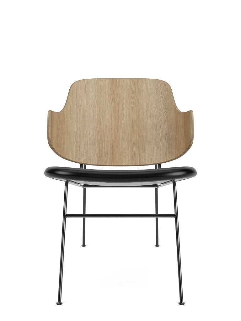 The Penguin Lounge Chair seen from the front, with a curved natural oak back and black Dakar leather upholstered seat.