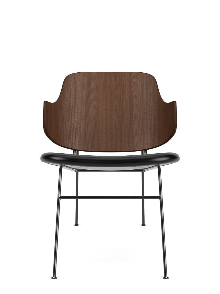 The Penguin Lounge Chair shown from the front with a curved walnut backrest and black Dakar leather upholstered seat.