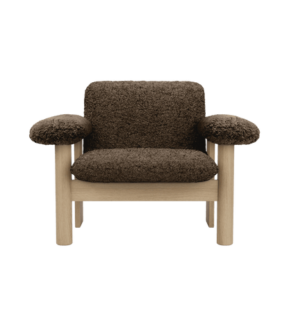 Front view of the Brasilia Lounge Chair, Low Back, upholstered in dark brown sheepskin with a natural oak frame.