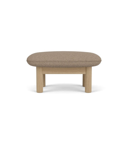 The Brasilia Ottoman upholstered in Logan Flint textile with a solid natural oak frame, seen from the front.