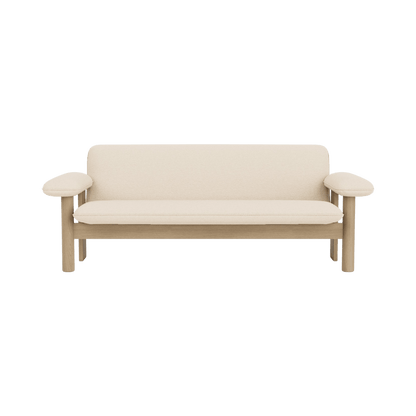 Front view of the Brasilia Sofa featuring a natural oak wood frame and plush cream bouclé textile upholstery.