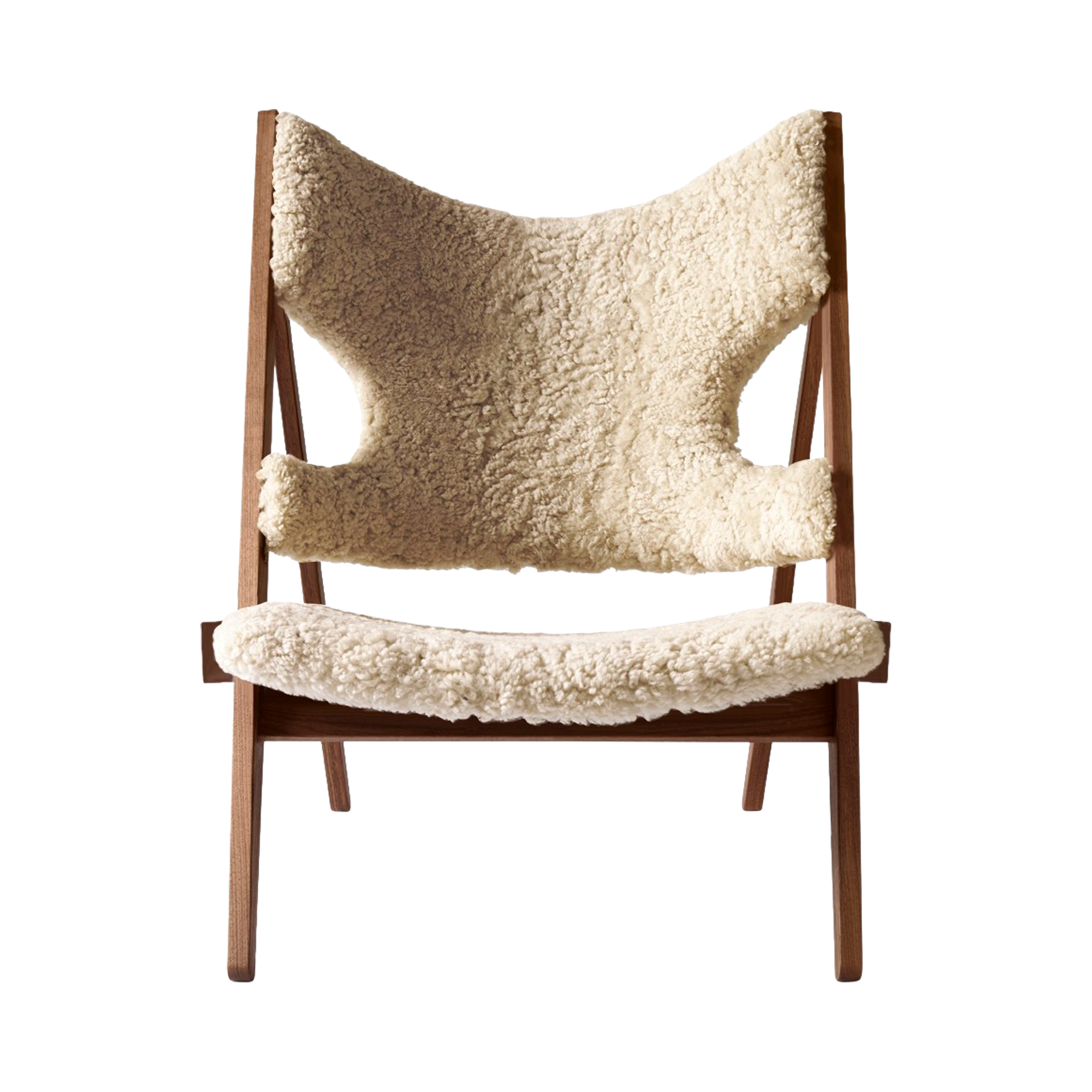 Front view of the Knitting Chair in solid walnut with natural sheepskin upholstery against a white background.