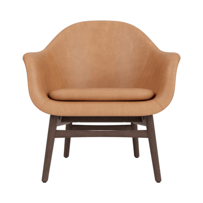 Front view of the Harbour Lounge Chair upholstered in camel leather with a dark-stained oak wood base.