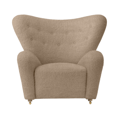 Front view of The Tired Man Lounge Chair upholstered in textured beige Baena fabric with a wide winged backrest.