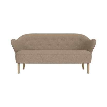Ingeborg Sofa in Logan Flint textile upholstery featuring a buttoned back and natural oak legs viewed from the front.