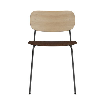 Co Dining Chair without arms, featuring a natural oak veneer back and black bouclé seat on a black powder-coated frame.