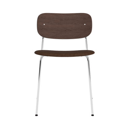 Co Dining Chair featuring a chrome frame, dark stained oak backrest, and black bouclé upholstered seat, front view.