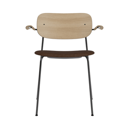 Co Dining Chair with Arms, featuring a black boucle upholstered seat, natural oak back, and a black steel frame.
