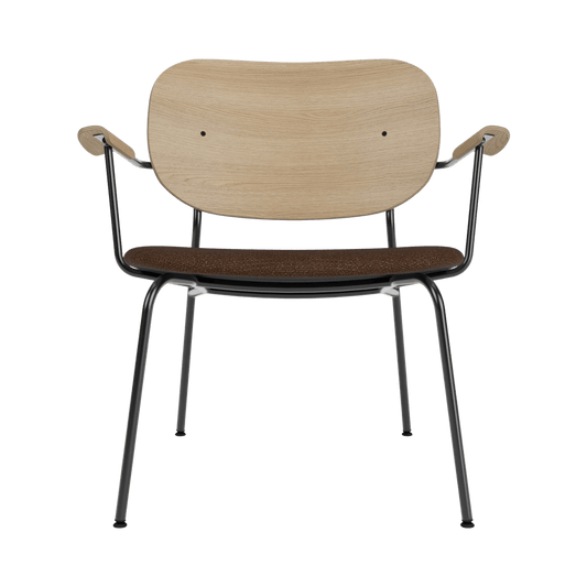 Front view of the Co Lounge Chair with a natural oak backrest and brown bouclé seat on a black powder-coated steel frame.