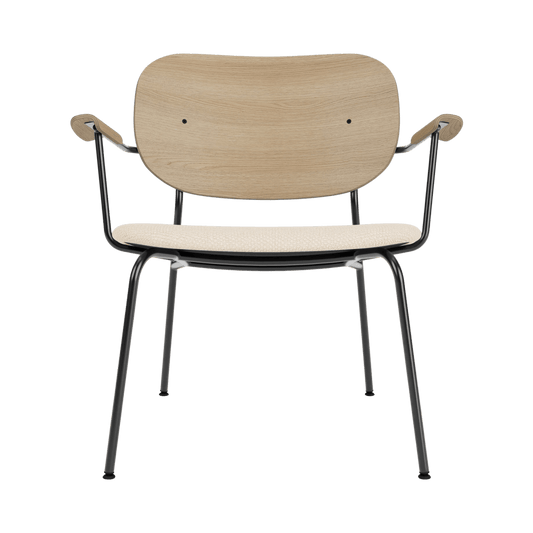Co Lounge Chair featuring a Logan Jasmine upholstered seat, natural oak backrest, and black powder-coated steel frame.