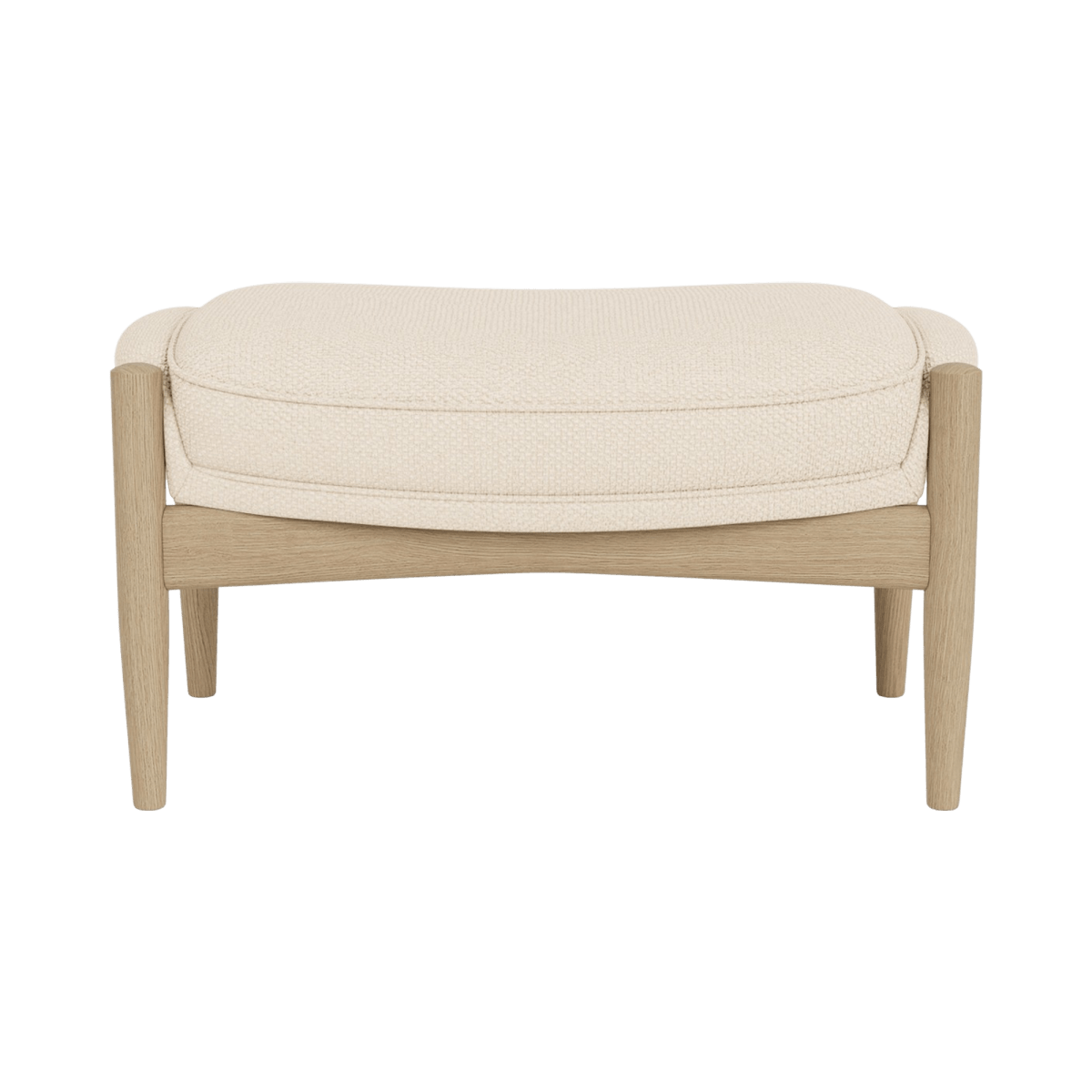 The Seal Ottoman in natural oak with Logan Jasmine upholstery, featuring a curved wooden frame and cushioned seat.