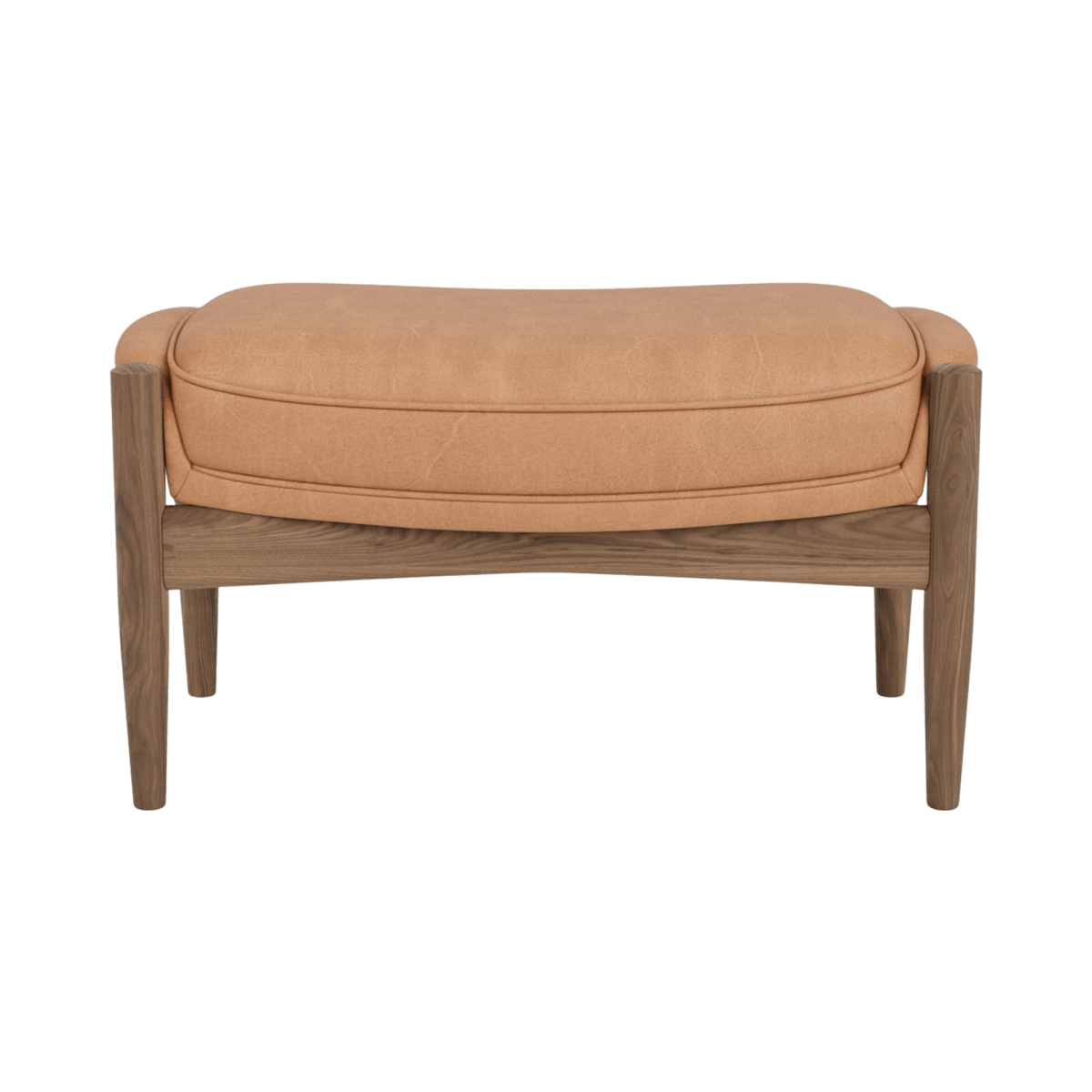 The Seal Ottoman upholstered in camel leather featuring a wooden walnut finish frame against a plain background.
