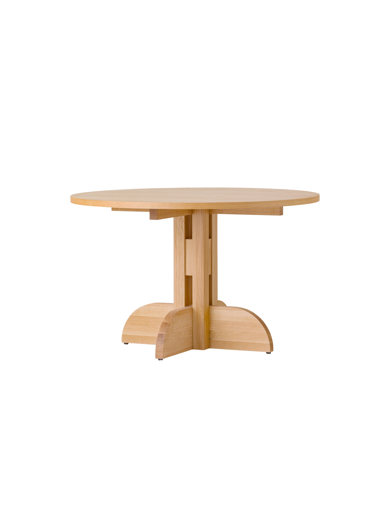 Puffin Dining Table, Round, in natural oak with a sculptural solid wood base, shown at an angle against a white background.