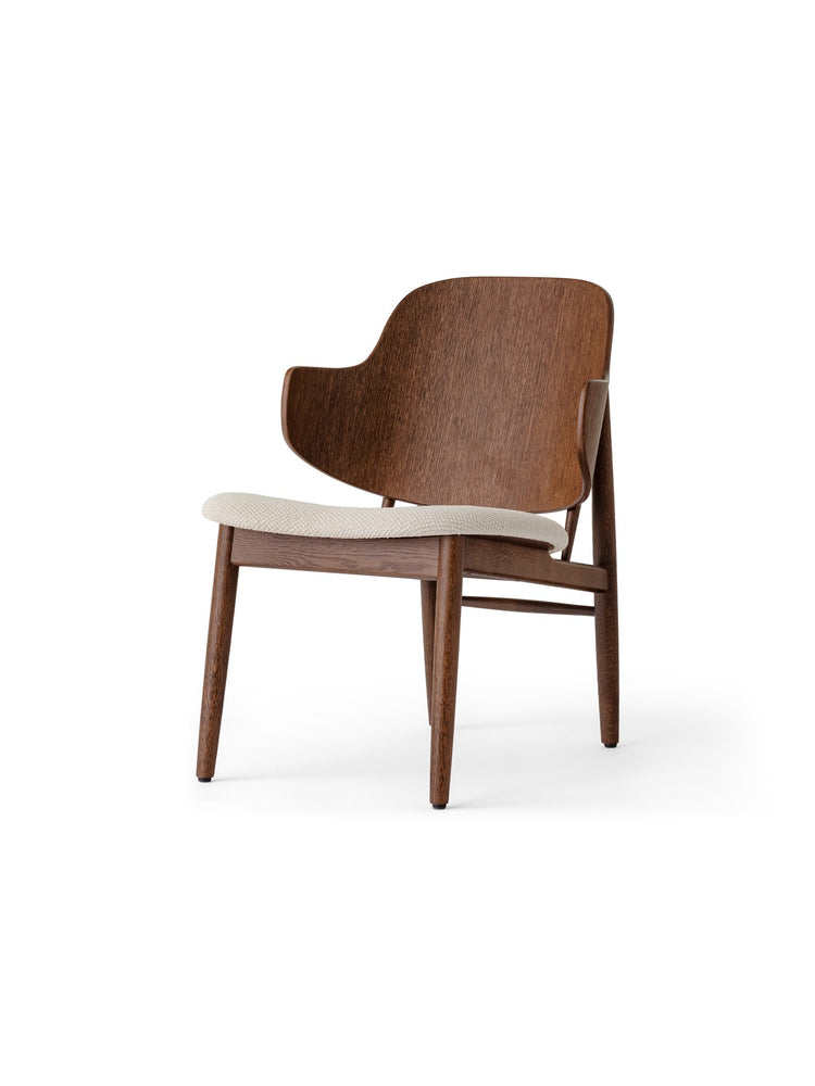 Mid-century style dark walnut wood chair with curved backrest and cream upholstered seat, three-quarter front view.