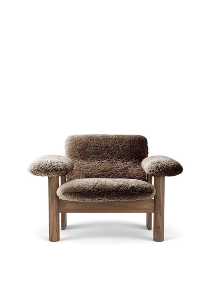 Front view of the Brasilia Lounge Chair with low back, featuring a dark wood frame and upholstered in thick, brown sheepskin.