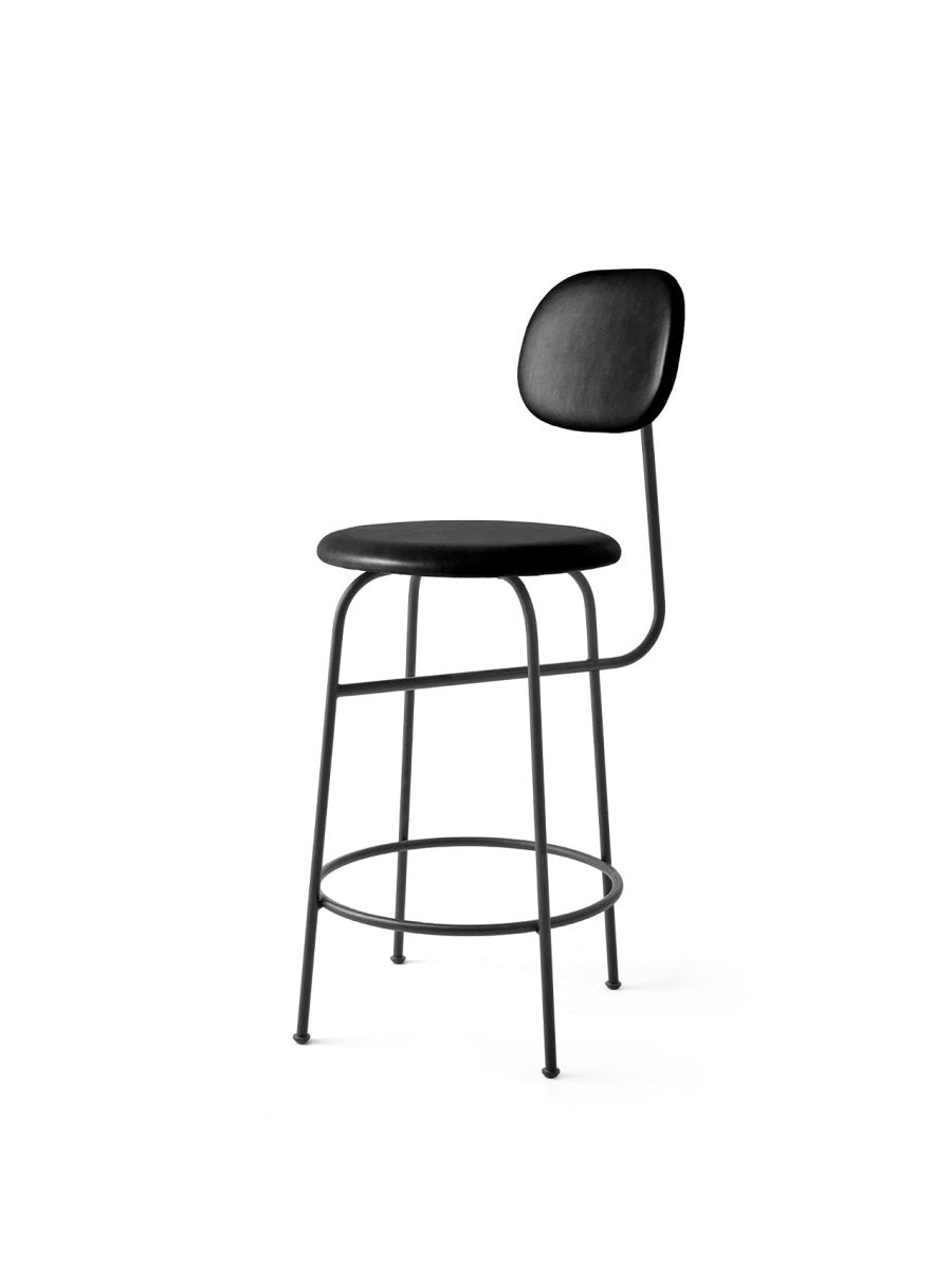 Angled view of the Afteroom Counter Chair Plus, featuring black Dakar leather upholstery and a minimalist black steel frame.
