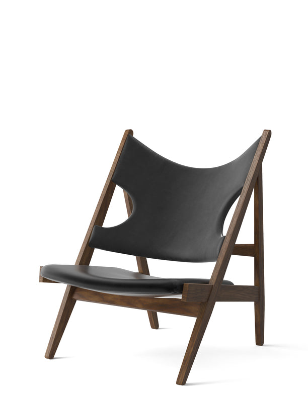The Knitting Chair with solid walnut frame and black Dakar leather upholstery against a white background.