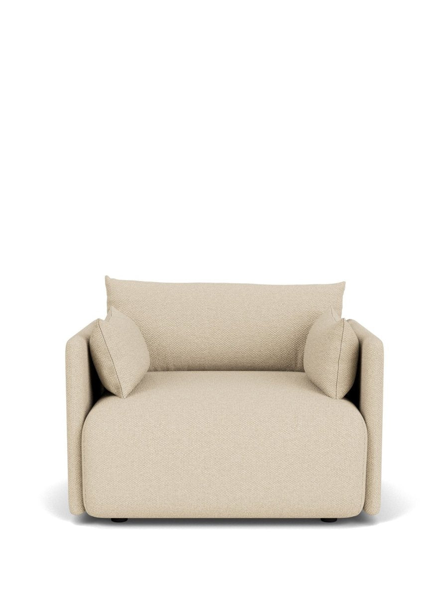 Beige upholstered lounge chair with rounded square shape, textured fabric and two side cushions, front view