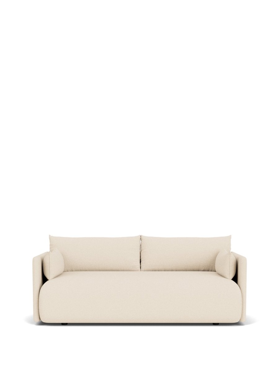 Cream upholstered two-seater sofa with rounded edges, removable back cushions and cylindrical bolster pillows, front view.