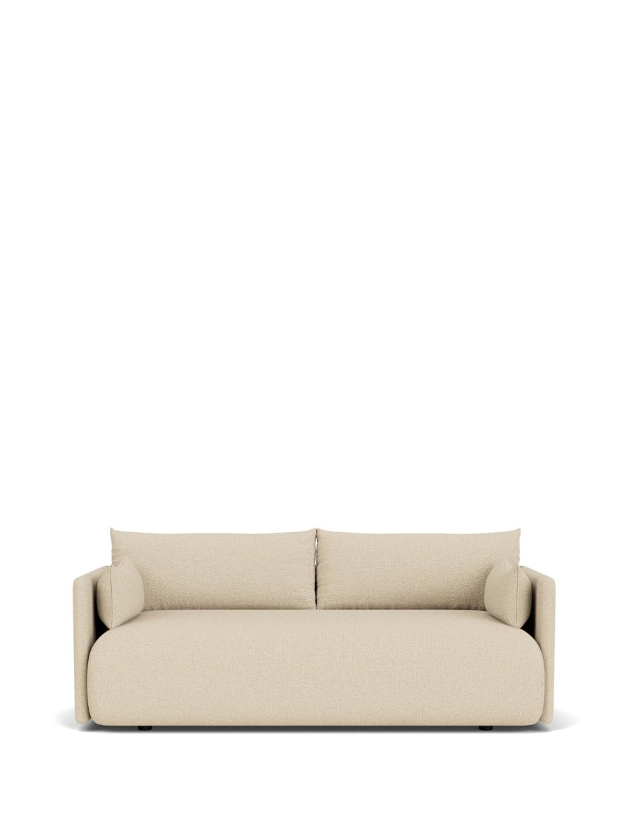 Beige upholstered two-seater sofa with rounded edges, low back cushions and cylindrical bolster pillows, front view