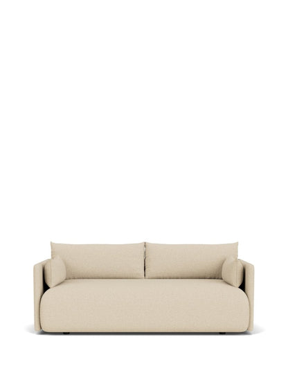 Beige upholstered two-seater sofa with rounded edges, low back cushions and cylindrical bolster pillows, front view