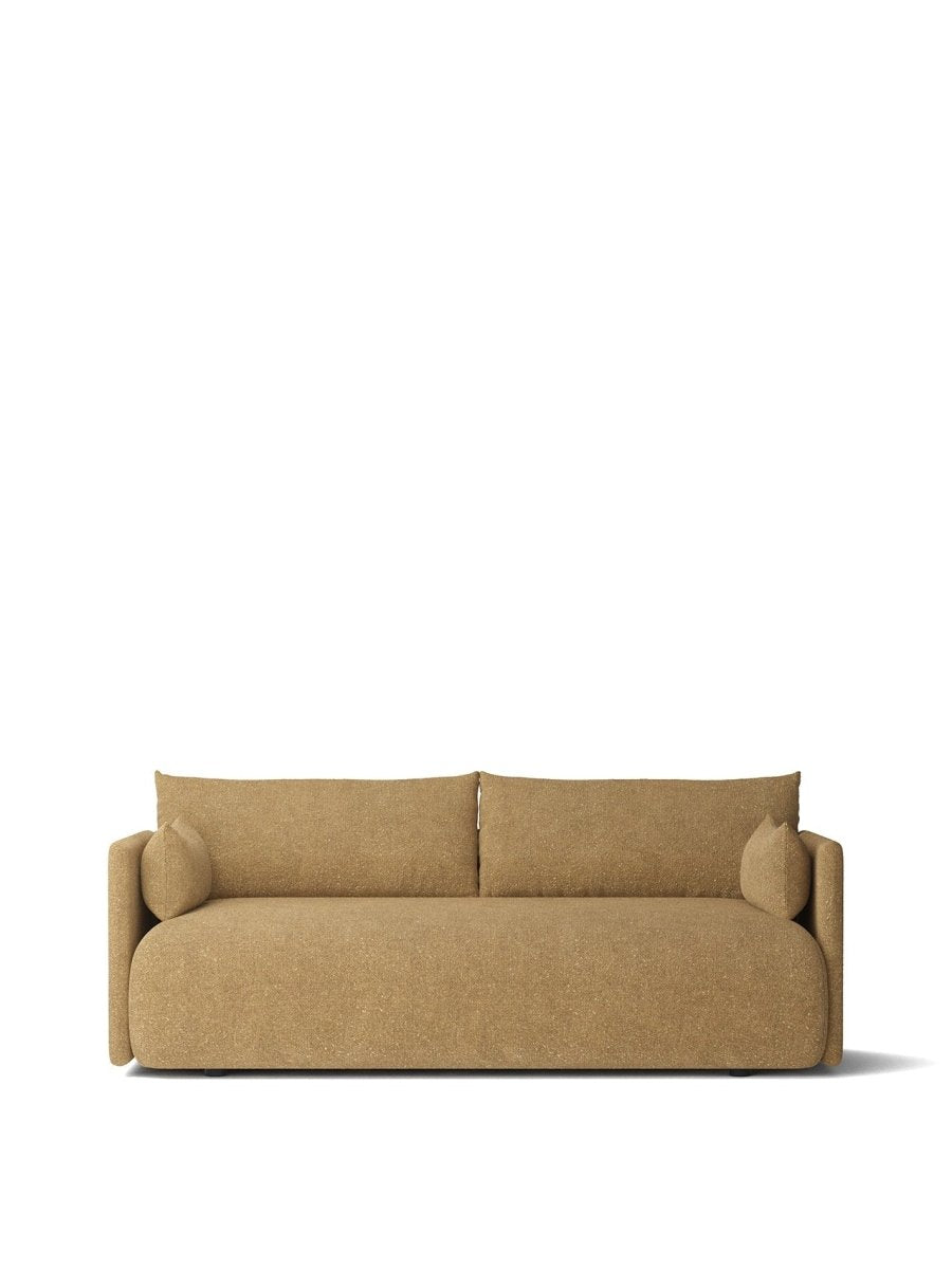 Beige textured fabric two-seater sofa with rounded edges, low back cushions and cylindrical bolster pillows.