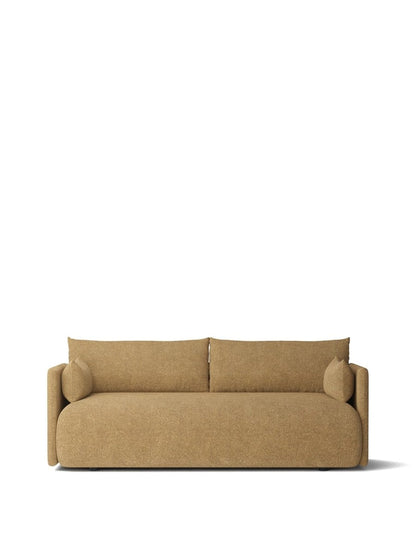 Beige textured fabric two-seater sofa with rounded edges, low back cushions and cylindrical bolster pillows.