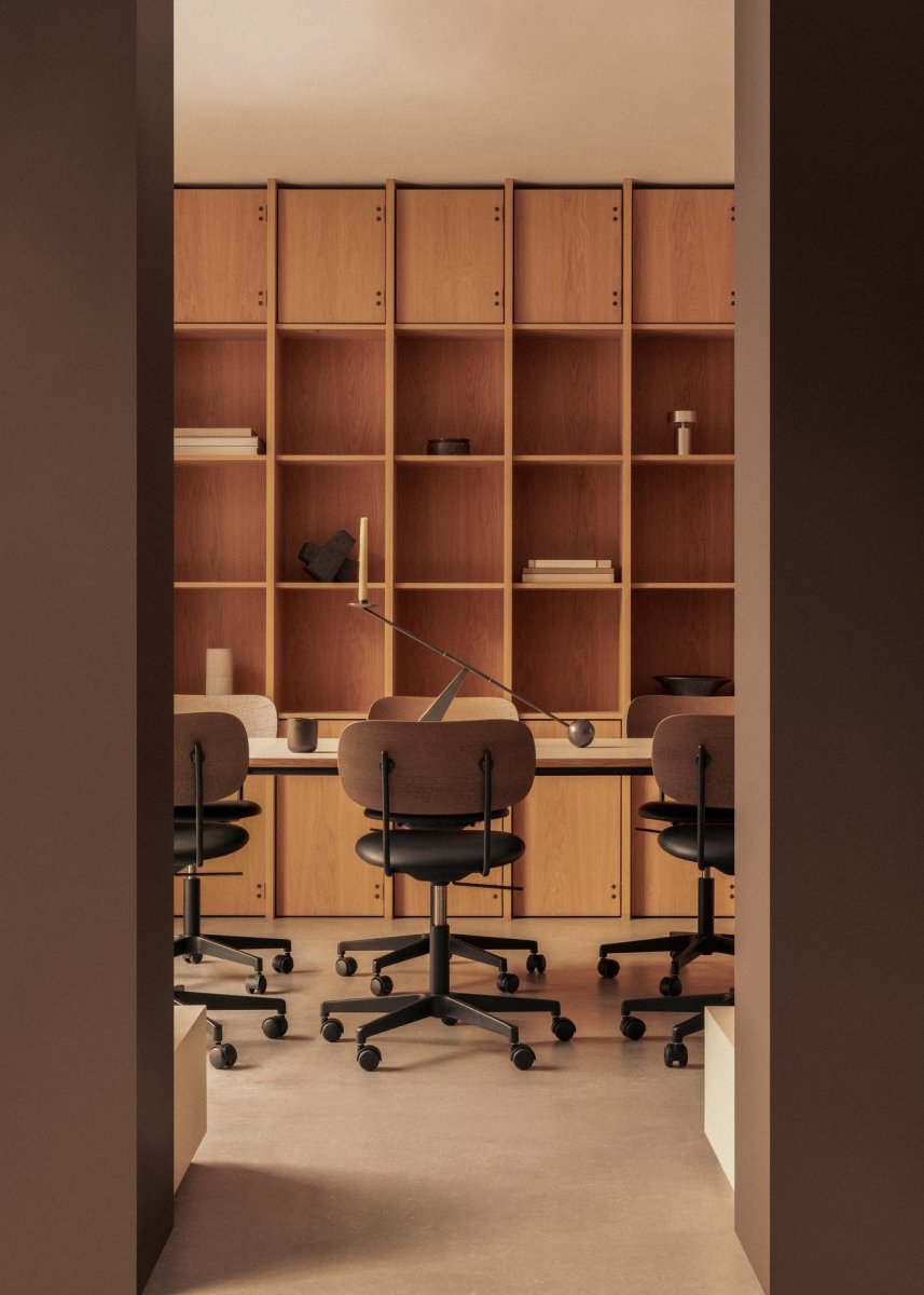Upholstered Co Task Chairs at a Co Table with an Interconnect Candleholder against a wall of wooden shelving.