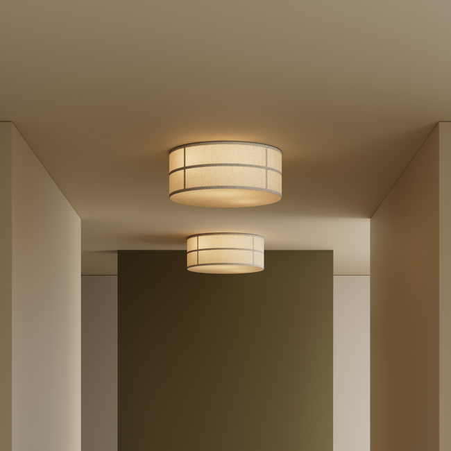 Ceiling-mounted cylindrical fabric pendant light in warm beige with horizontal and vertical seam detailing