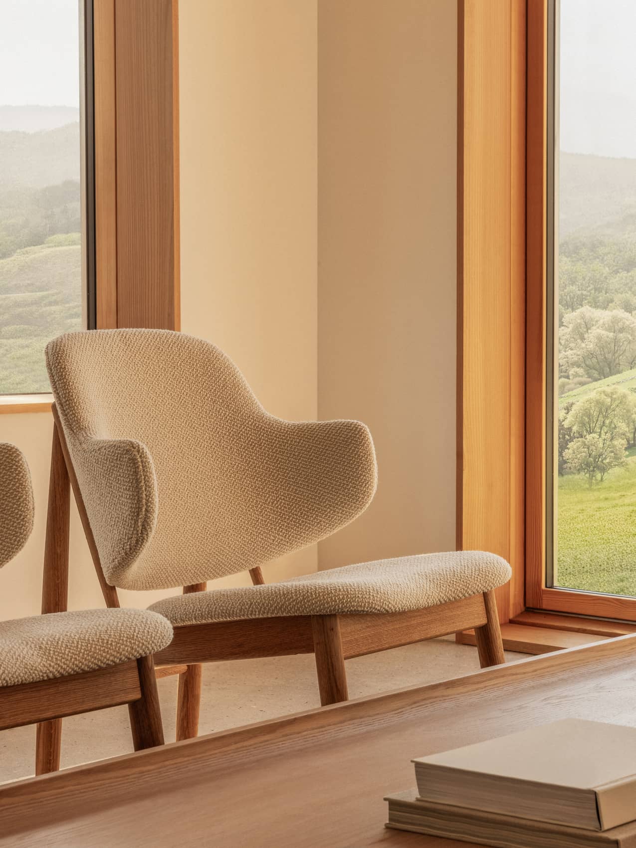 Penguin Wooden Lounge Chair in Logan Fossil upholstery and oak, positioned by a window and Conrad Lounge Table.