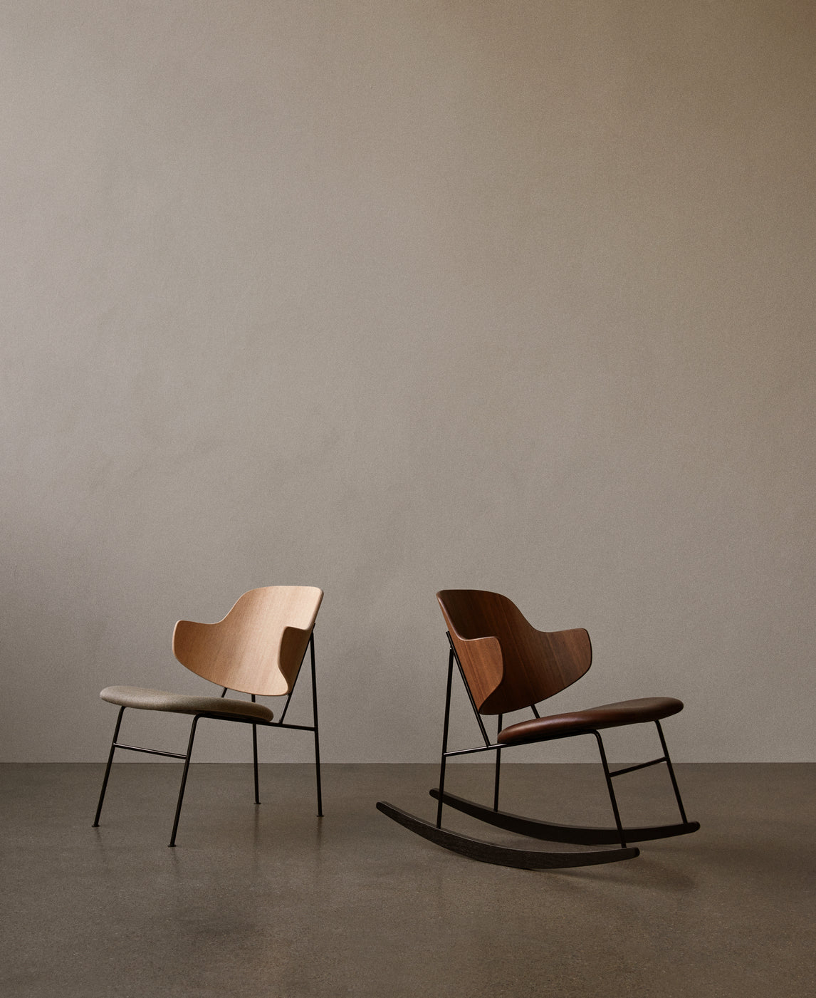 Pair of minimalist lounge chairs: one beige wood seat with fabric cushion, one walnut rocking chair with leather seat and