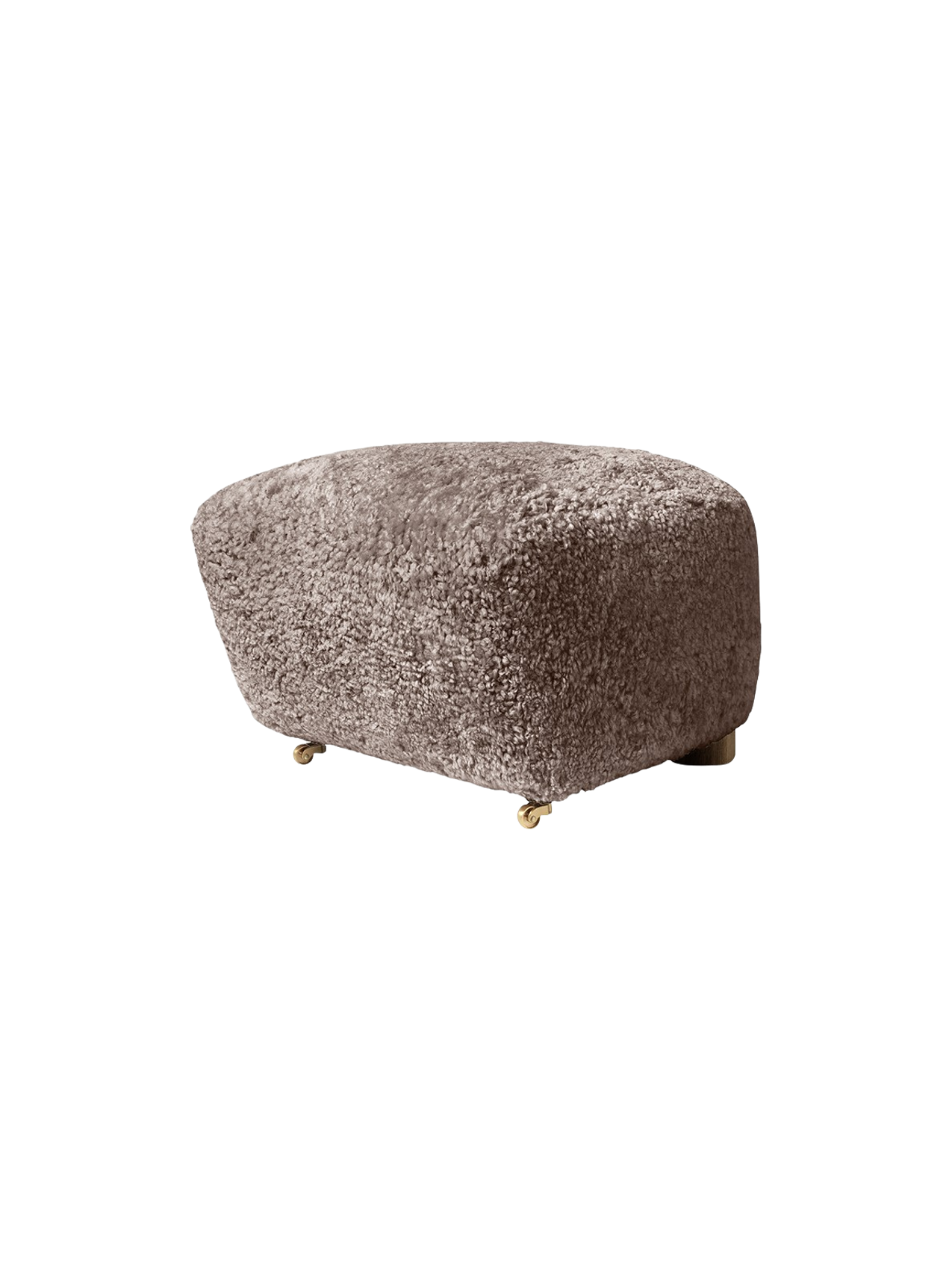 The Tired Man Ottoman upholstered in sheepskin Sahara, shown from the side with small brass castors.